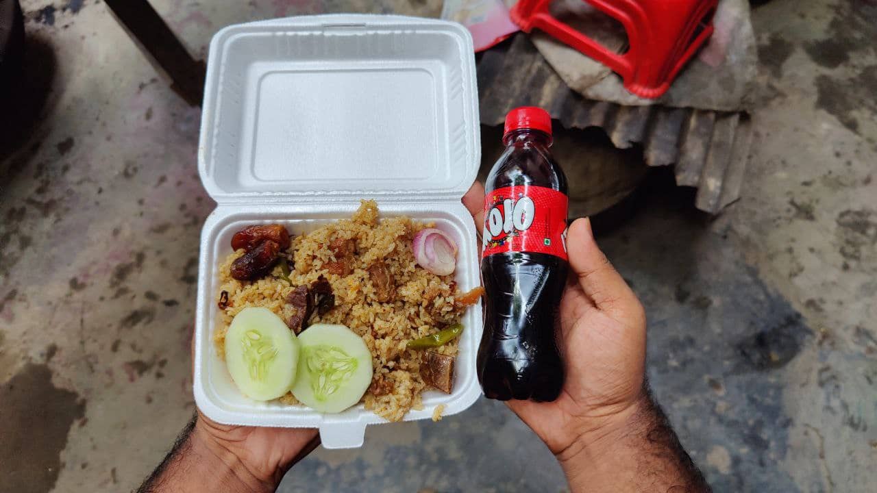 A poor holding some foods and drinks which has been given through Project Free Hospitality.